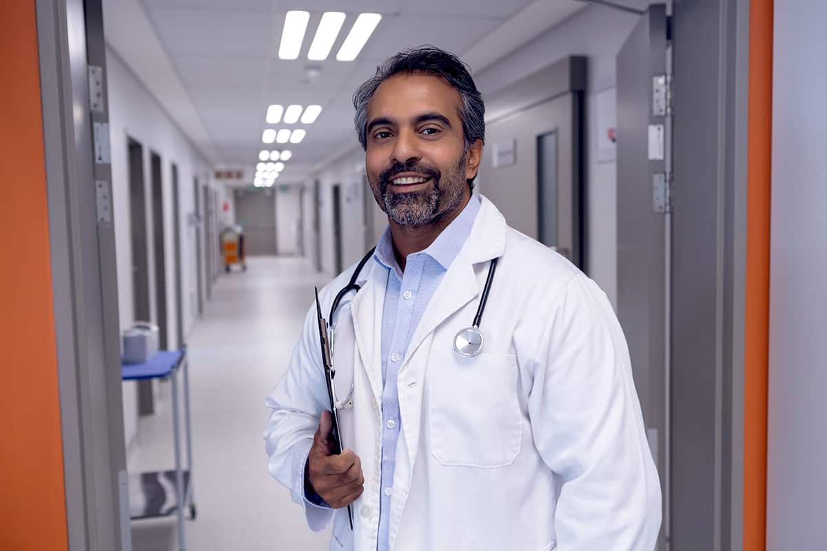A care-provider manager reviewing a sponsor-licence compliance folder - sponsoring care workers carries duties that continue long after the visa is granted.