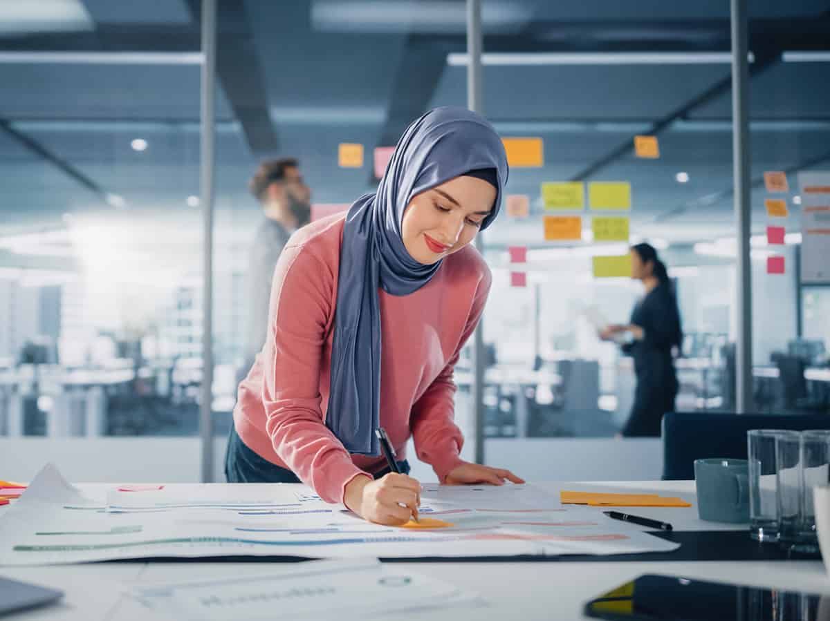 An HR manager and a compliance officer reviewing Key Personnel roles - the Authorising Officer, Key Contact and Level 1 User have real duties from day one.